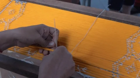 Hands Threading Silk With Ikat Method With Big Needle Stock Footage 120965612