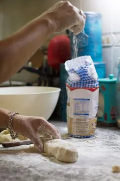Hands throwing flour on the dough Stock Photos