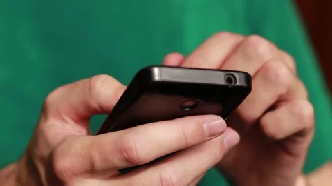 Hands thumbing through a smartphone closeup Stock Footage 73506285