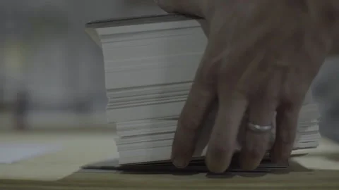 Hands tidying up a stack of invitation papers and take it out Stock Footage 160519553