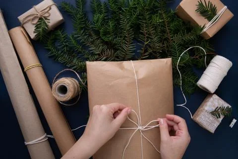Hands tie a string on a bag with a Christmas present Stock Photos