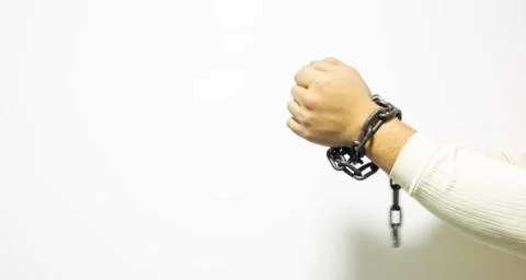 Hands with a tied chains on background. Stock Photos