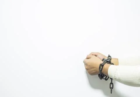 Hands with a tied chains on background. Stock Photos