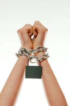 Hands tied up with chains Stock Photos
