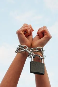 Hands tied up with chains Stock Photos
