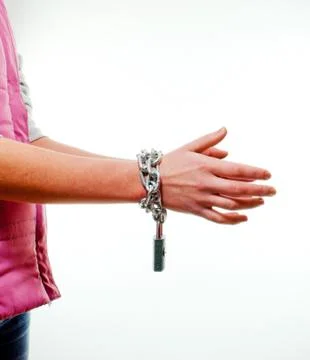 Hands tied up with chains Stock Photos