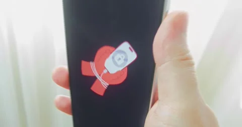 Hands tied with smartphone cable hold a smartphone, concept of addiction Stock Footage 313504844