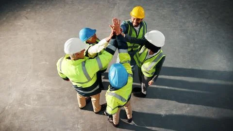 Hands together, team and engineer with above of people in building for Stock Photos
