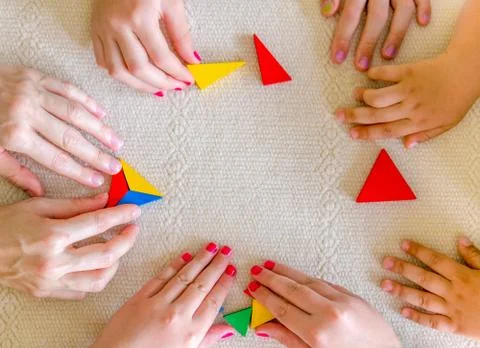 Hands together while playing tangram Stock Photos