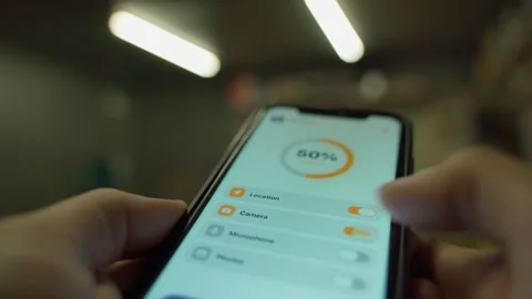 Hands toggling app permissions on smartphone privacy settings screen. Location Stock Footage 342912356
