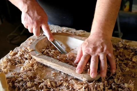 Hands with a tool on the background of a carpentry workshop. Stock Photos