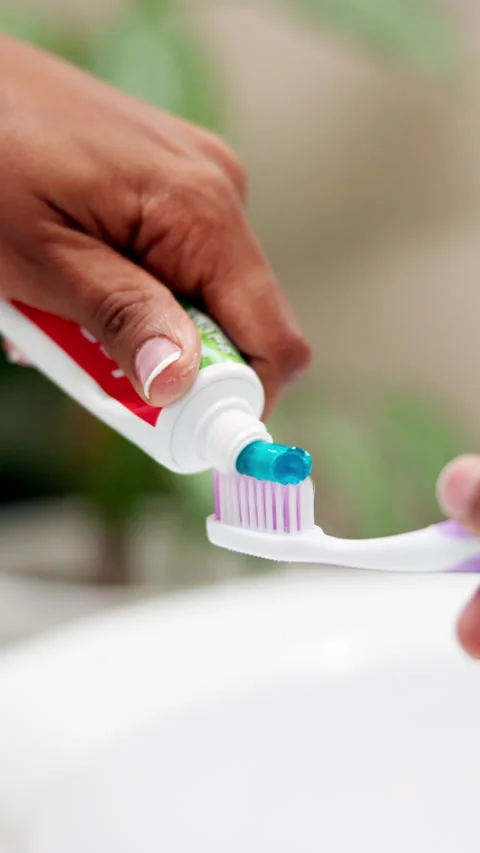 Hands, toothpaste and toothbrush in bathroom, home or product for cleaning mouth Stock Footage 306464356