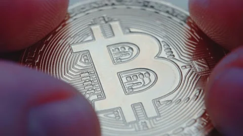 Hands touch and study the bitcoin coin. Future of virtual concept. Video stock 151111322
