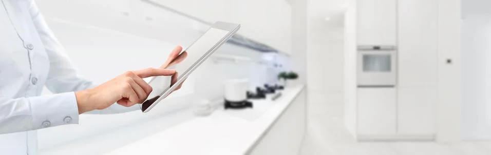 Hands touch the digital tablet on kitchen background smart home automation we Stock-Fotos