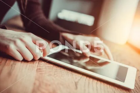 The hands touch the tablet on the table Stock Photos