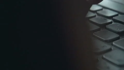 Hands touch typing on a laptop keyboard. Camera performs a circular overflew. Stock Footage 112075339