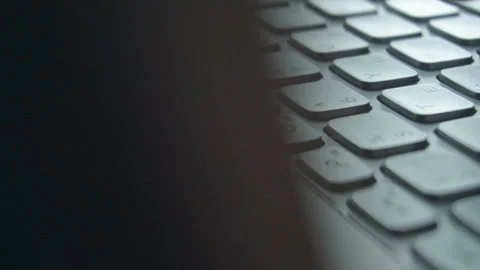 Hands touch typing on a laptop keyboard. Camera performs a circular overflew. Stock Footage 112075719