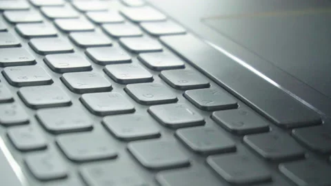 Hands touch typing on a laptop keyboard. Camera performs a circular overflew. Stock Footage 112076271