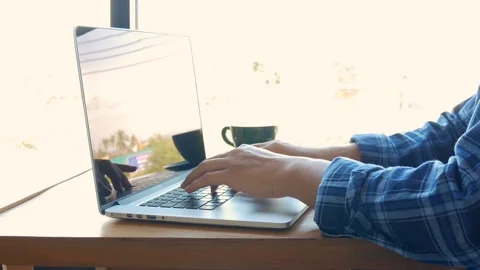 Hands touch typing on a laptop keyboard with blank screen, anonymous face Stock Footage 135048645