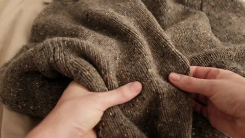 Hands touching brown sweater Video stock 316920659