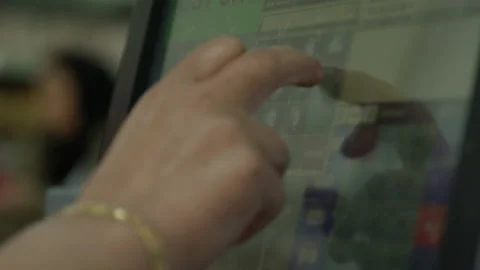 Hands touching buttons on a touch screen cash register Stock Footage 135780486