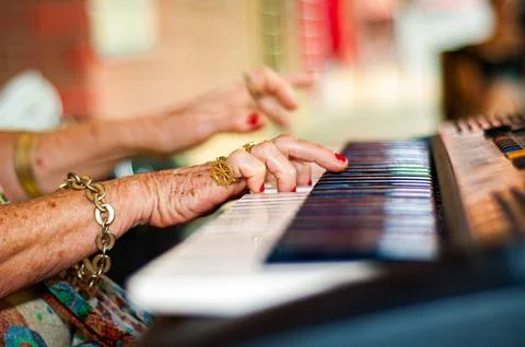 Hands touching a musical keyboard. Stock Photos