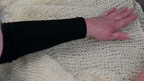 Hands touching soft knitted fabric, cream yarn texture, close up textile mo.. Stock Footage 334753075