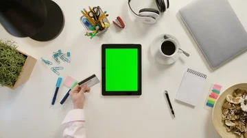 Hands Touching a Tablet and Holding a Credit Card Stock Footage 86046176