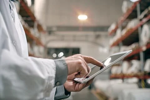 Hands touching tablet screen, working at factory Stock Photos