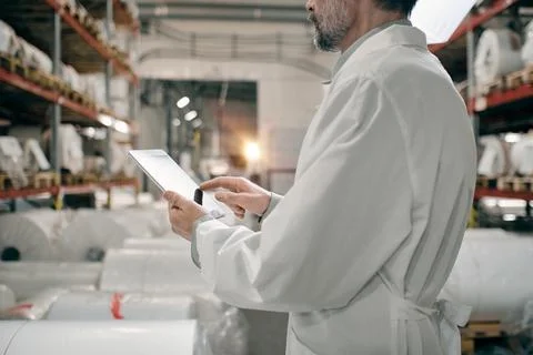Hands touching tablet screen, working at factory Stock Photos