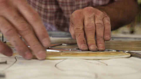 Hands trace outline on paper for stained glass window Stock Footage 33063993
