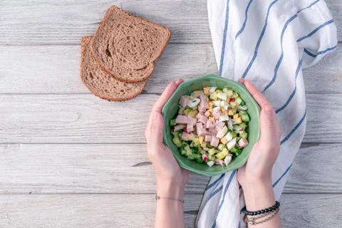 Hands with Traditional russian cold soup okroshka ingredients with some of it Stock Photos