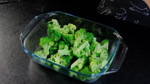 Hands Transferring Broccoli Florets into Baking Dish in Cooking Kitchen Stock Footage 341426973