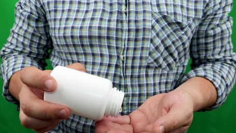Hands tremble during the counting of tablets. The concept of hand tremor, hangov Video stock 91987265