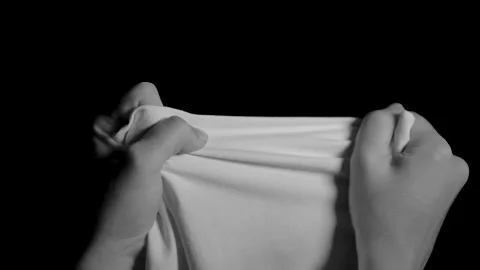 Hands try to tear a white cloth. Stock Footage 149058086