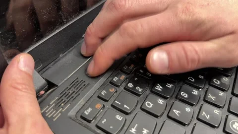 Hands trying to power on old laptop by pressing keyboard button, outdated Stock Footage 337121455