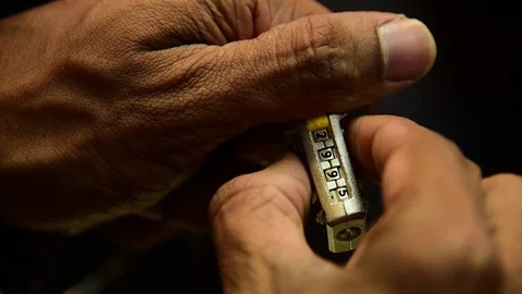 Hands trying to unlock code of a lock on black background Stock Footage 84934142
