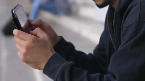 The hands of a Tunisian man using digital tablet in the city Video stock 218585492