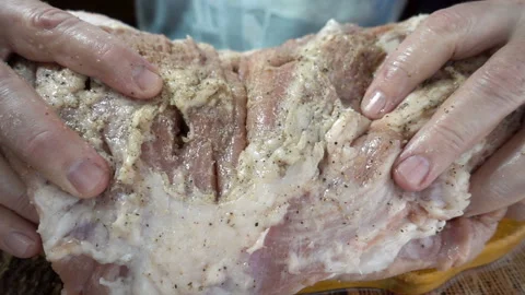 Hands turn over in slow motion a piece of raw meat Stock Footage 129192836