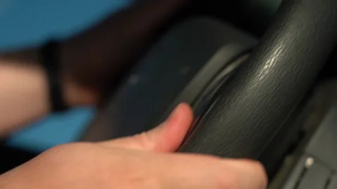 Hands turn the steering wheel. Stockbeeldmateriaal 156380033