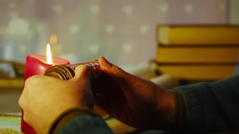 Hands Turning Cryptex Code Lock, Tension and Secret Puzzle in Candlelight Stock Footage 334084343