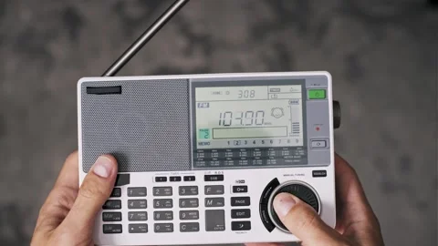 Hands Turning Dial on White Portable Radio Receiver Stock Footage 319068041