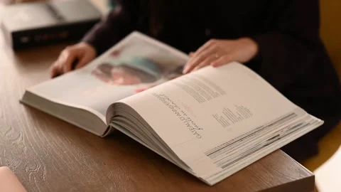 Hands Turning Page of big Book. Reading Stock Footage 263734640