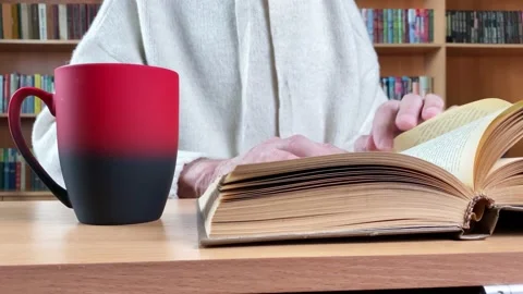 Hands turning pages of book in library Stock Footage 170182429
