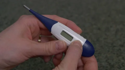 Hands turning on thermometer Video stock 142540375