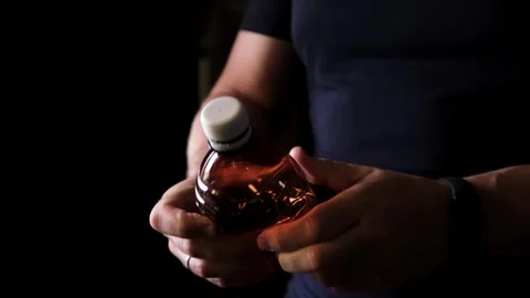 Hands twisting plastic bottle crumpled plastic reducing concept. Hands crushed a Stock Footage 323733356
