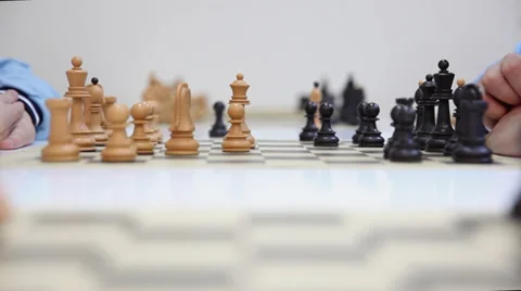 Hands of a two chess players and black queen take white queen Stock Footage 36265589