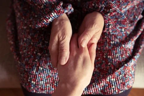 Hands of two generations holding each other Stock Photos