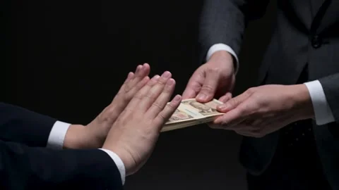 Hands of two men refusing a bundle of new Japanese yen notes Stock Footage 336765842