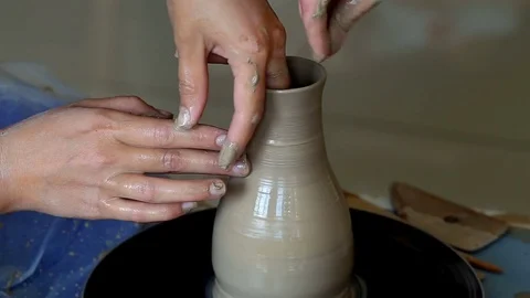 Hands of two people create pot, potter's wheel. Teaching pottery Stock Footage 78142733